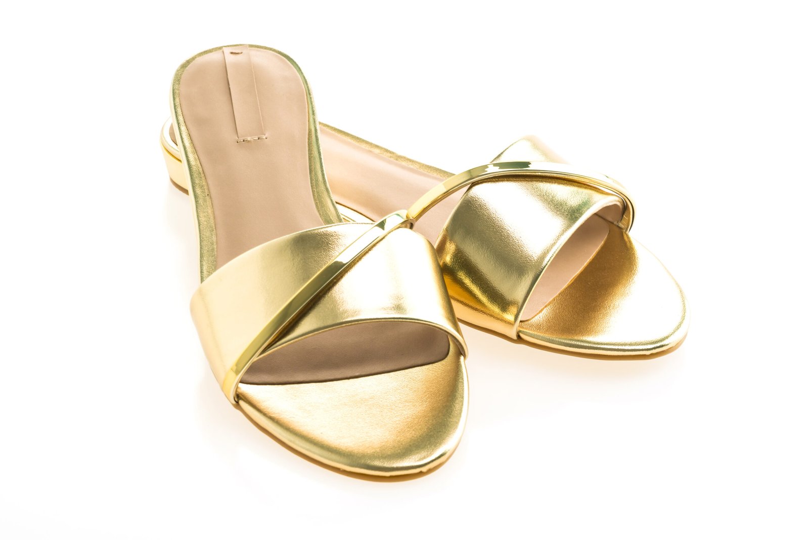 Beautiful gold sandal shoes for woman isolated on white background