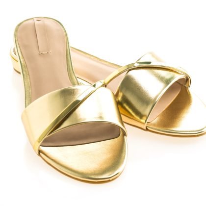 Beautiful gold sandal shoes for woman isolated on white background